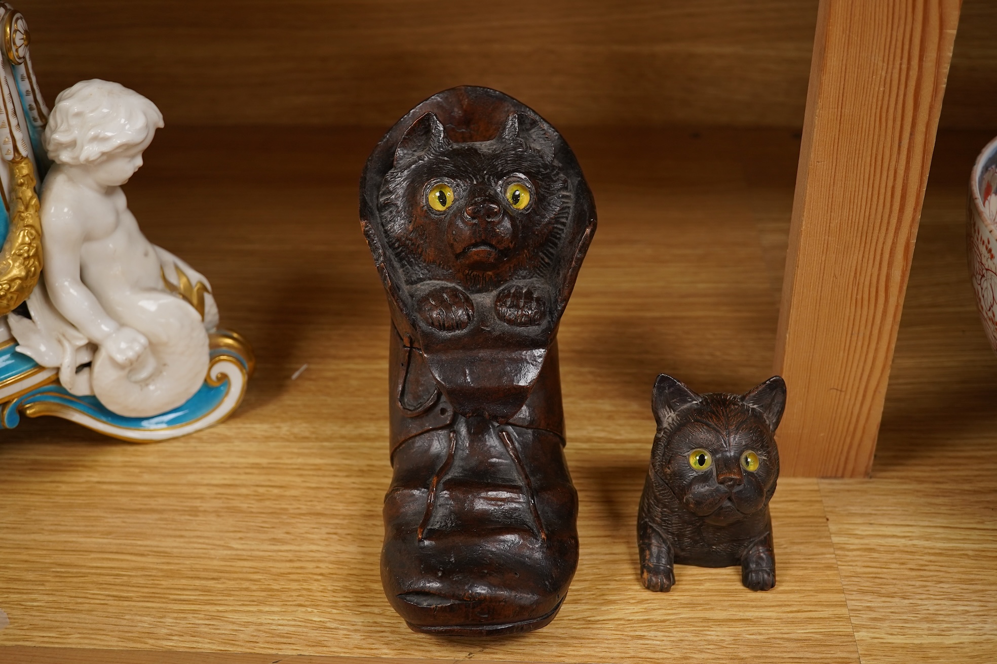 A Black Forest carving of a kitten in a boot inkwell and another car inkwell, tallest 15cm